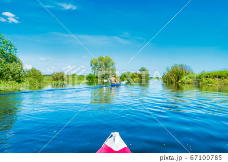 Kayak trip on blue river landscape Kayak trip on blue river landscape 67100785