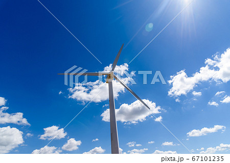 Wind turbines for power generation on hill against blue sky 67101235