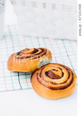 A cinnamon bun on a napkin on white 67101486