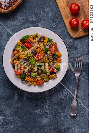 Pasta salad with tomato, broccoli, black olives. Pasta salad with tomato, broccoli, black olives. 67103132