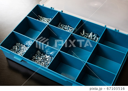 Plastic box with cells on wooden table 67103516