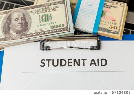 Financial help for student statement. Money on the laptop. 67104802