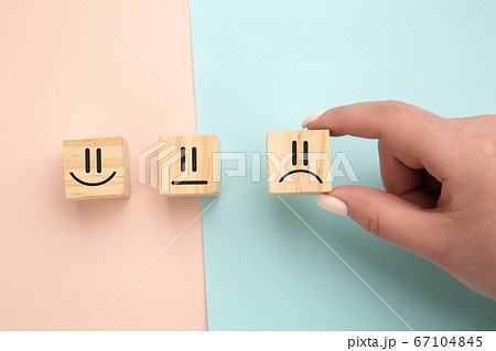 Customer showing rating with unhappy icon on colorful background, customer satisfaction survey concept, copy space. Customer showing rating with unhappy icon on colorful background, customer satisfaction survey concept, copy space. 67104845