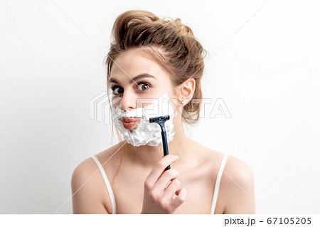 Woman shaving her face by razor Woman shaving her face by razor 67105205
