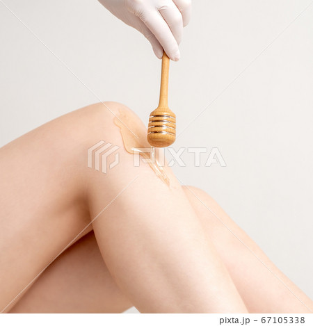 Wax flowing down on female leg Wax flowing down on female leg 67105338