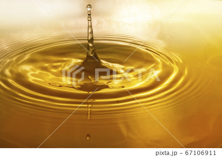 Drops of water on the surface of the water spreading and forming waves Drops of water on the surface of the water spreading and forming waves 67106911