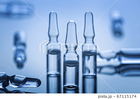 Groupe of medical glass ampules on blue background 67115174