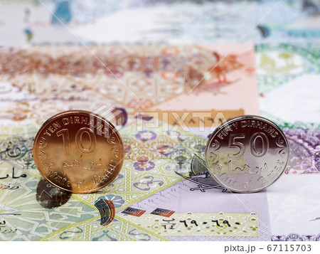 Qatari coins - riyal on the background of money 67115703