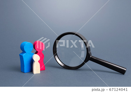 Figurines symbolizing the family and magnifying glass. Demographic policy. Gene research. Demographic studies, population. Search for couples to adopt orphaned children, integration into society. 67124041