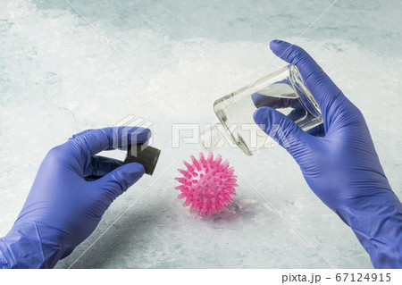 hand in latex gloves holding anticeptic cologne hand in latex gloves holding anticeptic cologne 67124915