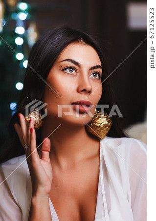 Beautiful brunette with big balls in the shape of toys for the Christmas tree Beautiful brunette with big balls in the shape of toys for the Christmas tree 67125523