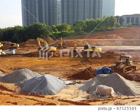 KUALA LUMPUR, MALAYSIA -JULY 17, 2019: Heavy machinery doing the soil backfilling work at the construction site. Works carried out before building construction starts to get the required levels.  67125583