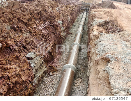 SEREMBAN, MALAYSIA -AUGUST 01, 2019: Underground utility and services pipe laid by workers in the trenches at the construction site. Installation of pipes still ongoing. SEREMBAN, MALAYSIA -AUGUST 01, 2019: Underground utility and services pipe laid by workers in the trenches at the construction site. Installation of pipes still ongoing. 67126547