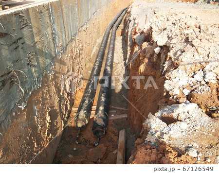 SEREMBAN, MALAYSIA -AUGUST 01, 2019: Underground utility and services pipe laid by workers in the trenches at the construction site. Installation of pipes still ongoing. SEREMBAN, MALAYSIA -AUGUST 01, 2019: Underground utility and services pipe laid by workers in the trenches at the construction site. Installation of pipes still ongoing. 67126549