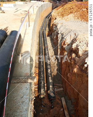 SEREMBAN, MALAYSIA -AUGUST 01, 2019: Underground utility and services pipe laid by workers in the trenches at the construction site. Installation of pipes still ongoing. SEREMBAN, MALAYSIA -AUGUST 01, 2019: Underground utility and services pipe laid by workers in the trenches at the construction site. Installation of pipes still ongoing. 67126551