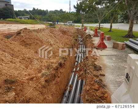SEREMBAN, MALAYSIA -AUGUST 01, 2019: Underground utility and services pipe laid by workers in the trenches at the construction site. Installation of pipes still ongoing.     67126554