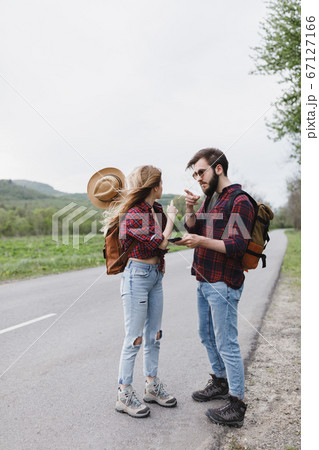 Girl And Boyfriend Standing On Road And Waiting の写真素材