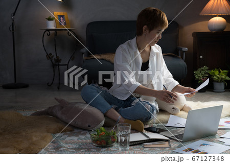 Asian woman in casual clothing using laptop working indoors at home 67127348