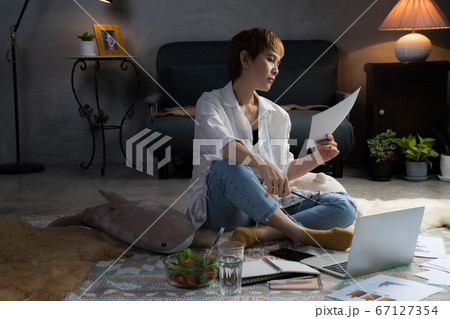 Asian woman in casual clothing using laptop working indoors at home Asian woman in casual clothing using laptop working indoors at home 67127354