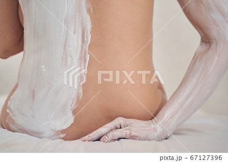 Soft white clay drying on the skin of beautiful lady Soft white clay drying on the skin of beautiful lady 67127396