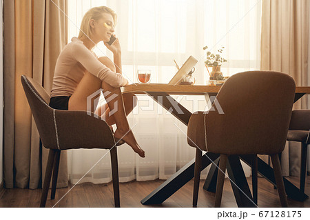 Caucasian female teleworker making a phone call 67128175