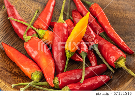 hot chili peppers piled in a wooden bowl close-up hot chili peppers piled in a wooden bowl close-up 67131516