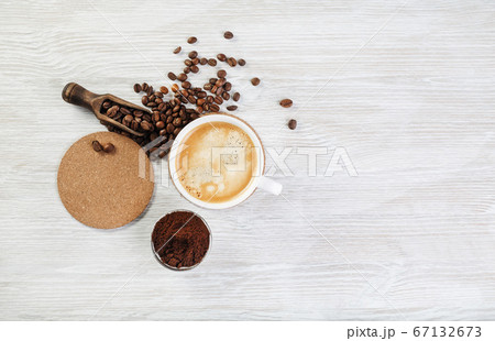Coffee on light wood table Coffee on light wood table 67132673