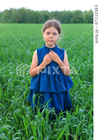 Beautiful little girl runs in the summer field Beautiful little girl runs in the summer field 67132883