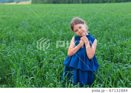 Beautiful little girl runs in the summer field Beautiful little girl runs in the summer field 67132884