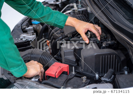 Professional mechanic hand providing car repair and maintenance service 67134115