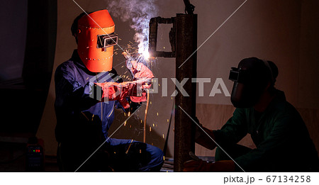 Metal welding steel works using electric arc welding machine 67134258