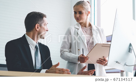 Two business people talk project strategy at office 67134517