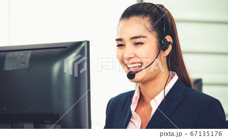 Business people wearing headset working in office Business people wearing headset working in office 67135176