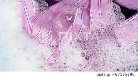 Color clothes soak in powder detergent water 67135390