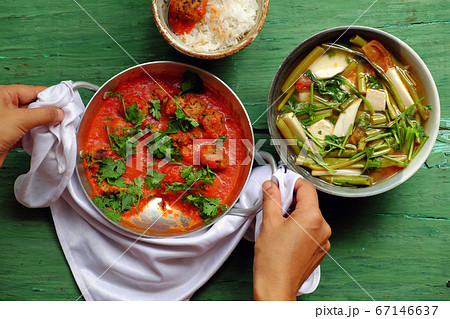 Vietnamese meal for lunch, vegetarian homemade food, tofu ball cook with tomato sauce, vegetable soup, rice bowl Vietnamese meal for lunch, vegetarian homemade food, tofu ball cook with tomato sauce, vegetable soup, rice bowl 67146637