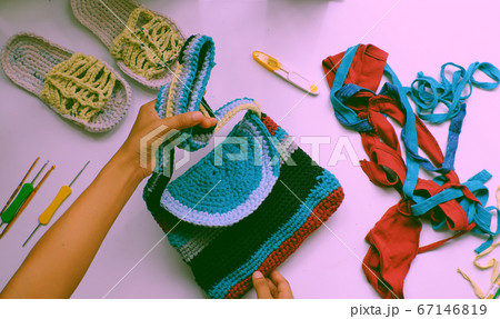 Close up from top view woman hand hold colorful handmade bag from recycle old t shirt 67146819