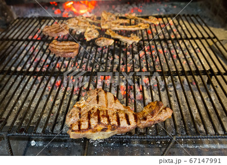 T-bone steak over the grill 67147991