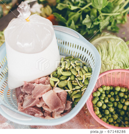 A person cooking Thai yellow curry with fish fillet and fresh ingredients coconut milk	 67148286