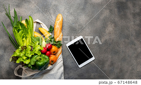 Eco bag with healthy food products and tablet computer. Top view. 67148648