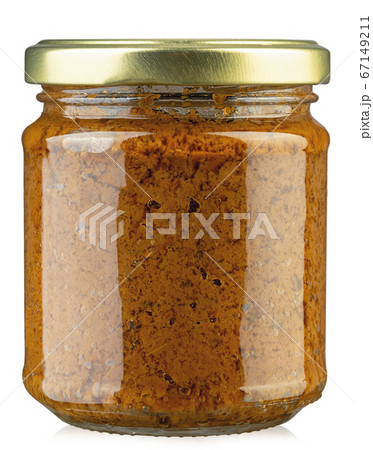 Closeup of jar with dried tomatoes pesto. 67149211