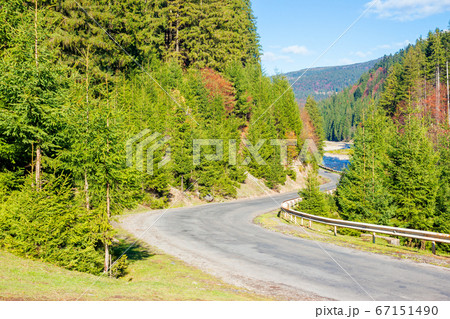 asphalt road through mountain valley. sunny asphalt road through mountain valley. sunny 67151490