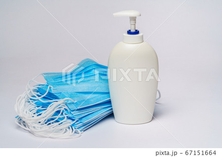 bottle of lotion, sanitizer or liquid soap and protective mask over light grey background bottle of lotion, sanitizer or liquid soap and protective mask over light grey background 67151664