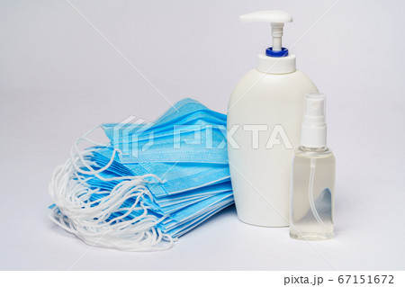 bottle of lotion, sanitizer or liquid soap and protective mask over light grey background bottle of lotion, sanitizer or liquid soap and protective mask over light grey background 67151672