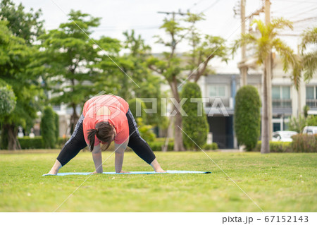 new normal concept,Young woman is happy to motivation exercise or yoga outdoor in the garden to control or lose weight.Obese fat woman have intention exercise to lose weight and build strong health. new normal concept,Young woman is happy to motivation exercise or yoga outdoor in the garden to control or lose weight.Obese fat woman have intention exercise to lose weight and build strong health. 67152143