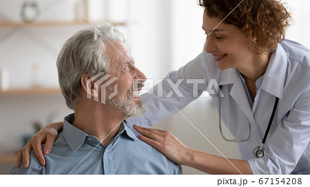 Smiling caring female nurse support senior patient Smiling caring female nurse support senior patient 67154208