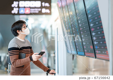 Asian man tourist wearing mask in airport terminal 67156642