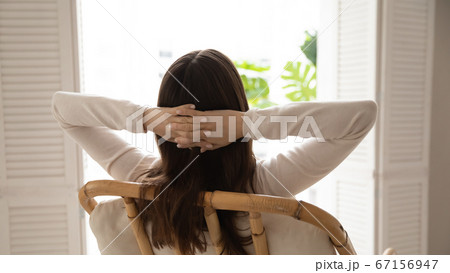 Rear view calm dreamy woman relaxing in cozy chair 67156947
