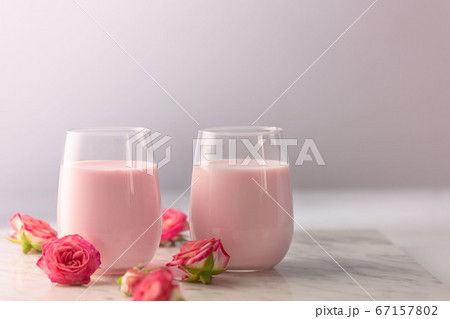 Moon milk prepares with pink rose flower. Trendy 67157802