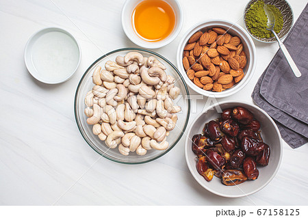 Ingredients in bowls for cooking raw vegan cake Ingredients in bowls for cooking raw vegan cake 67158125