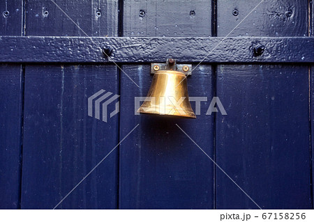 Traditional old door bell for ring on old wooden door, vintage background textue Traditional old door bell for ring on old wooden door, vintage background textue 67158256